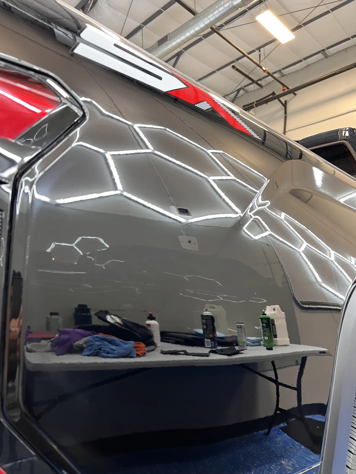 Flawless mirror-like reflection on a black car clear coat after multi-stage paint correction and wet sanding