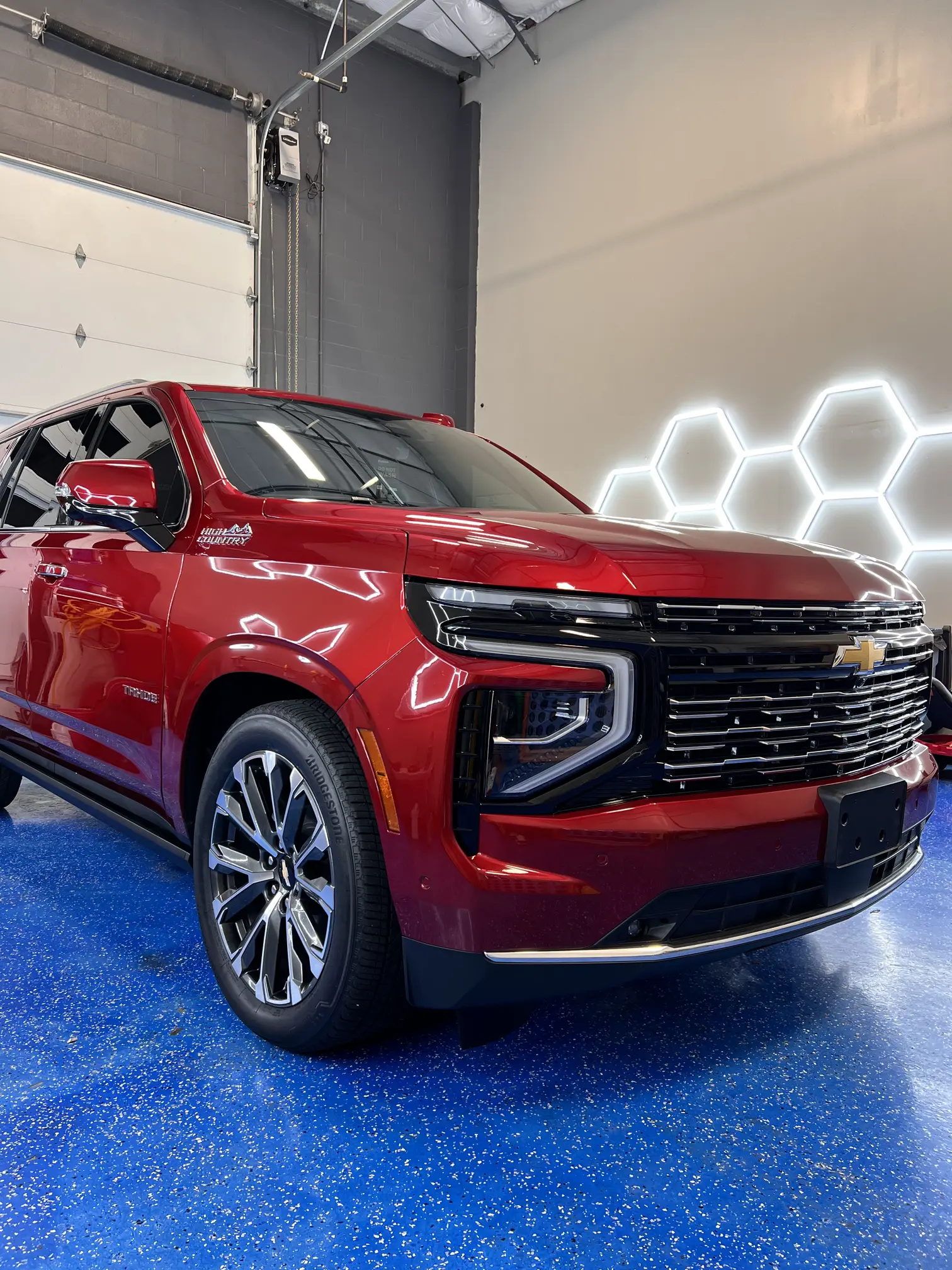 Glossy red Chevy SUV inside the climate-controlled studio at Slim’s Detailing Studio in Round Rock TX