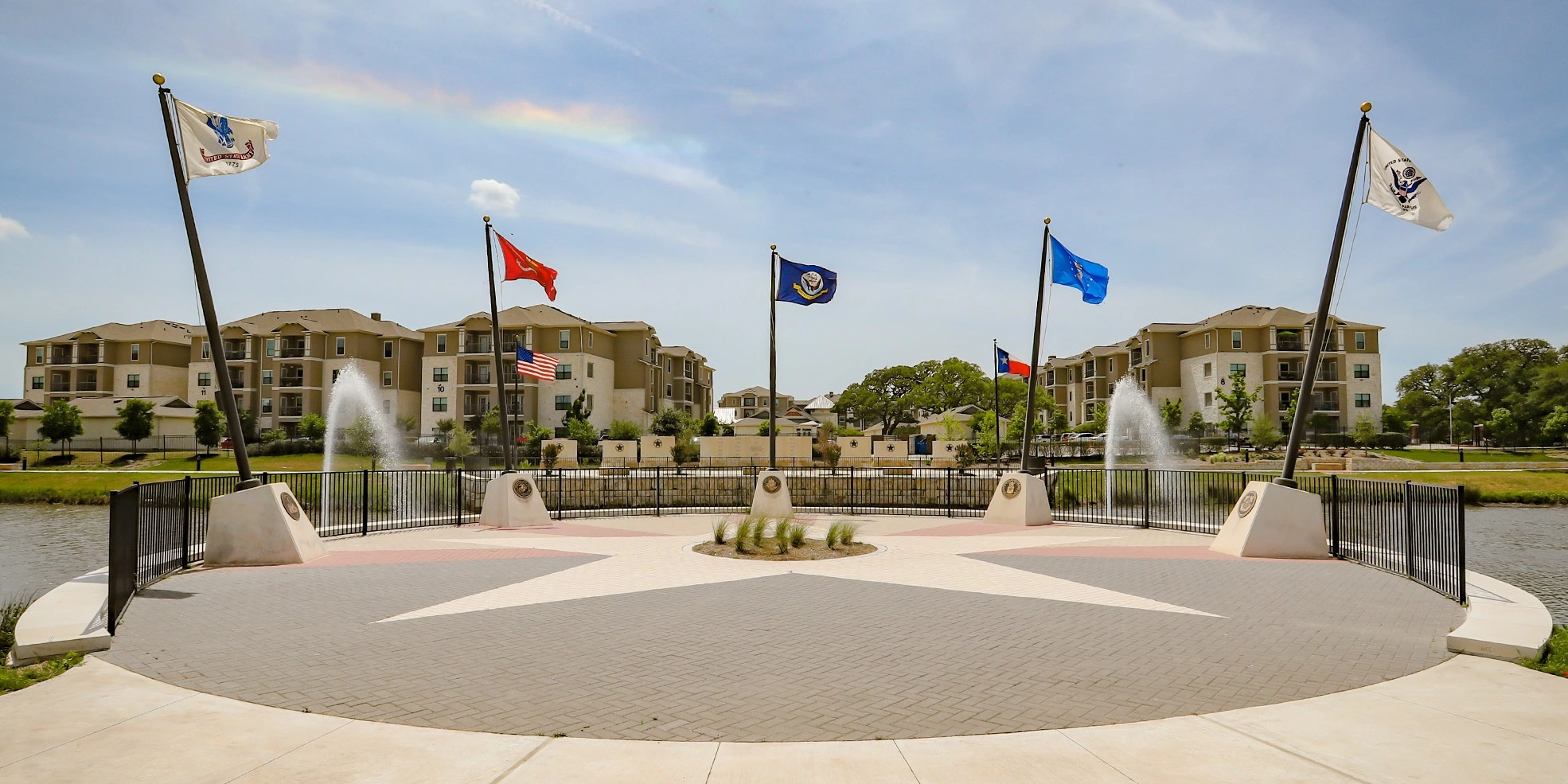 Scenic public park plaza with fountains and flags in Leander TX, a primary service area for Slim's Detailing Studio